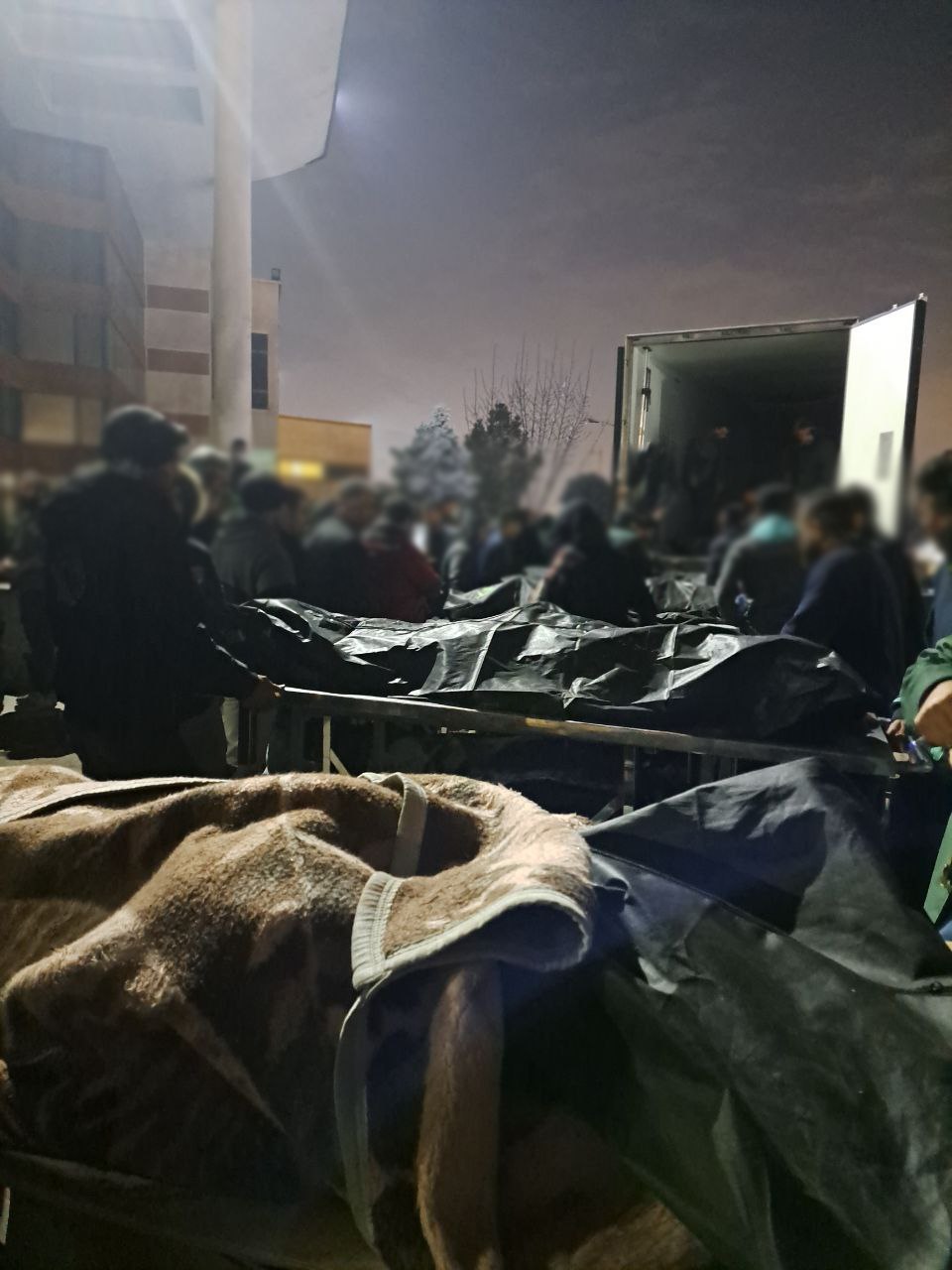 Bodies being loaded into a vehicle after protests in Iran
